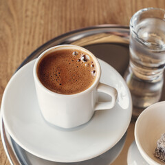 Traditional Turkish coffee with cold water and Turkish delight