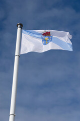 Galician flag waving against sky