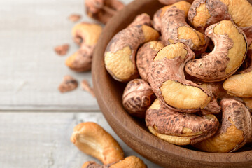 roasted cashew nuts in the wooden bowl on the table