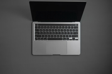 Fototapeta na wymiar Grey laptop on Grey background