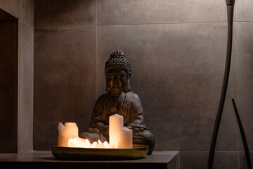 Photo of Buddha statue with set of candles