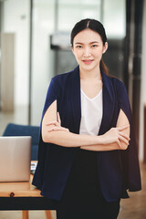 Asian businesswoman looking happy and looking at camera