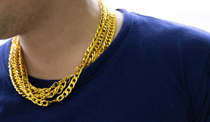 Close-up bearded man wearing gold necklace.