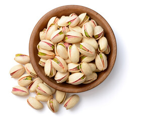 pistachios nuts in the wooden plate, isolated on white, top view