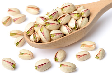 pistachio nuts with shell in the wooden spoon, isolated on the white background