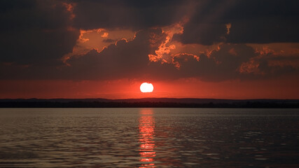 Colorful sky, lake and forest during sunset      