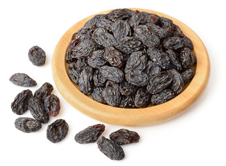 black raisins in the wooden bowl, isolated on white background