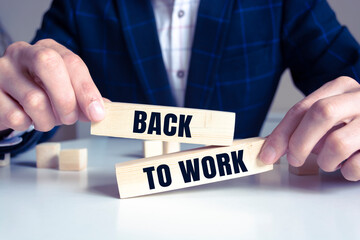Back to work word written on wood block.