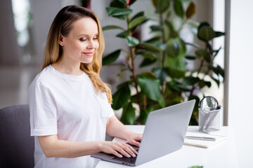 Profile side photo of young attractive woman happy positive smile work home laptop typing email...