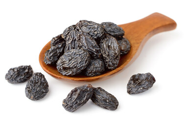 black raisins in the wooden spoon, isolated on white background