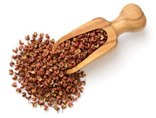 dried Szechuan peppercorns in the wooden scoop, isolated on the white background, top view