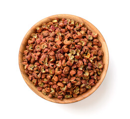 dried Szechuan peppercorns in the wooden bowl, isolated on the white background, top view