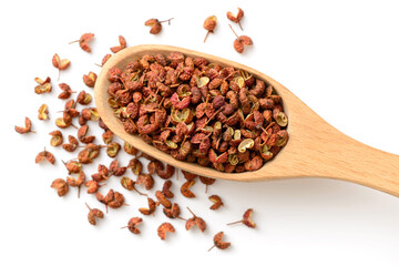 dried Szechuan pepper in the wooden spoon, isolated on the white background, top view
