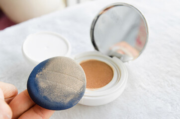 Obraz na płótnie Canvas Puff testing cushion foundation on case makeup background.