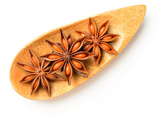 star anise in the wooden plate, isolated on the white background, top view