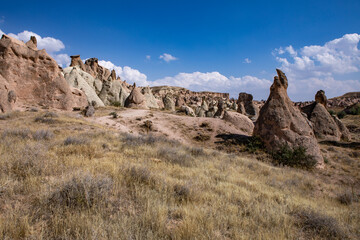 Fototapeta premium Cappadocia, Turkey - September 1, 2021 – Impressive nature by chimney rock formations and rock pillars of “love Valley” near Goreme, Cappadocia, Nevsehir, Turkey