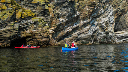 Exploring cliffs and sea caves on the coast between Latheronwheel and Lybster in Caithness in the...