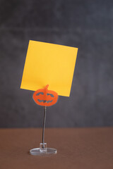Desktop holder for cards and notes in the form of a pumpkin. Halloween background idea. Themed...