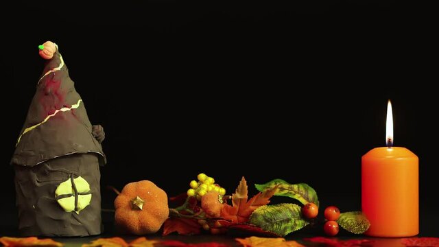 Burning candle, house, autumn pumpkin, Halloween congratulations. Isolated image on black background, copy space. Video, footage or background for splash screen, credits, cutouts, intro. UHD 4K.