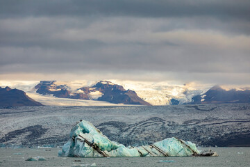 dramatic out of this world landscape image of  vast glacier field of  Vatnajökull  National park and floating icebergs in the nearby Glacier Lagoon in Jökulsárlón, Iceland.