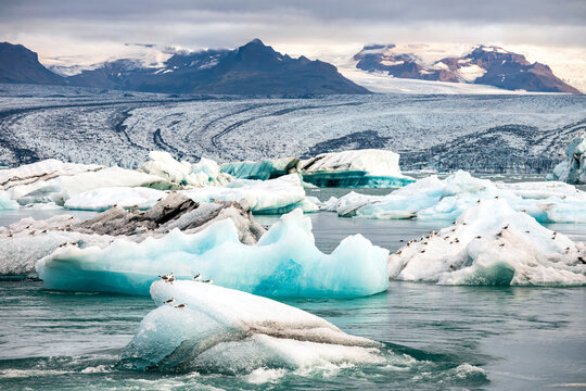 dramatic out of this world landscape image of  vast glacier field of  Vatnajökull  National park and floating icebergs in the nearby Glacier Lagoon in Jökulsárlón, Iceland.