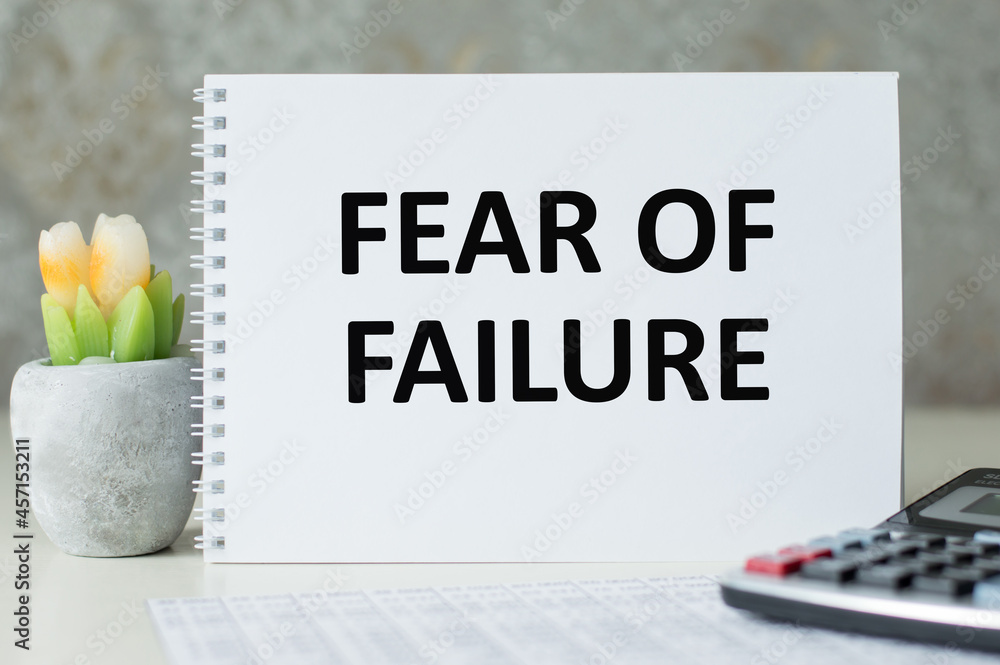 Poster fear of failure text on white paper notepad on light background. business concept