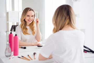 Obraz na płótnie Canvas Photo portrait young woman in white pajama doing gua-sha massage near mirror