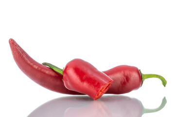 One whole and one half pod of hot red pepper, close-up, isolated on white.
