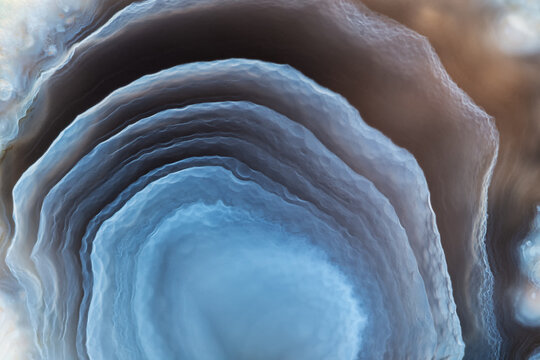 Full-screen stone texture. Fragment of blue layered agate.