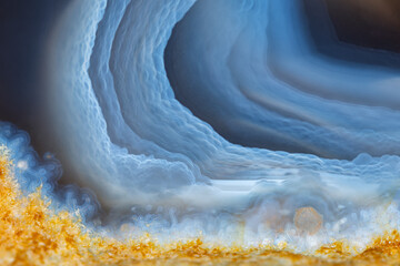 Full-screen view of blue transparent layered landscape agate.