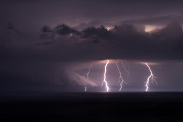 Naklejka na ściany i meble Multiple lightning bolts during a thunderstorm over the Black sea.