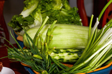 A pot of lettuce vegetables and green fruits close-up