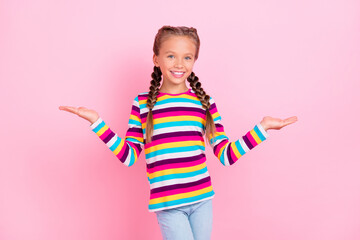 Photo of promoter small lady palms hold compare empty spaces wear striped shirt isolated pink color background