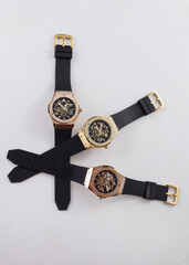 men's watch of gold color lie on a white background