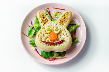 Funny and nice bunny shaped crumpets served with mix fresh vegetables, funny food for kids