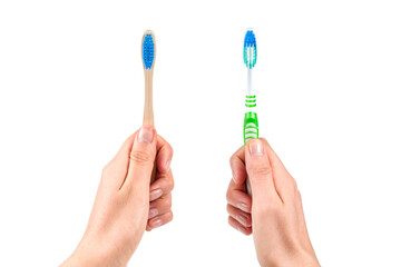 Hands with two toothbrushes on white background.