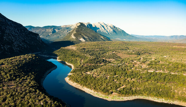 View from above, stunning aerial view of the Cedrino Lake - Lago del Cedrino surrounded by the mountain range of Supramonte located northeast of the Gennargentu massif. Sardinia, Italy.
