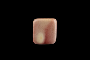Close-up Pink opal stone isolated on a black background.