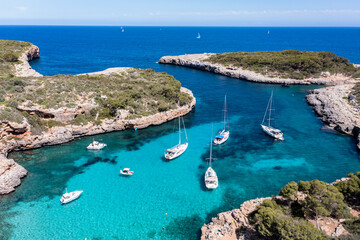 Aerial view, Cala Sa Nau, near Cala d'Or, with beaches and sailing boats, Migjorn region, Mallorca, Balearic Islands, Spain - obrazy, fototapety, plakaty