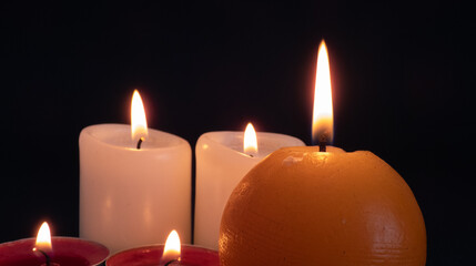 burning candles on black background