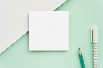 Sticky notes, memo pad, small notepad mockup on mint green background.