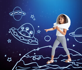 Contemporary artwork with little girl in huge white astronaut helmet standing among drawn planets,...