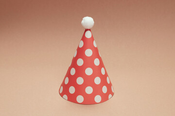 Colorful birthday cap on brown  background.