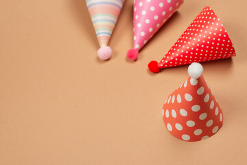 Colorful birthday cap on brown  background.