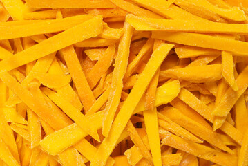 Dry tasty mango slices as a background.