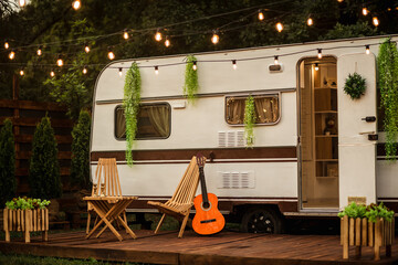 Wooden table and chairs near the trailer. Camping season. Photo studio.