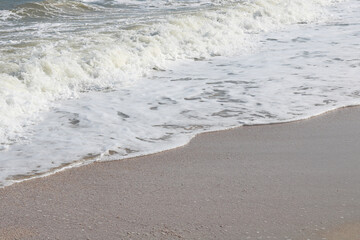 Beautiful seascape with waves and sea foam on shore