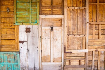 Collage of retro vintage style wooden doors with rusty latch and knockers for buildings or house facade - obrazy, fototapety, plakaty