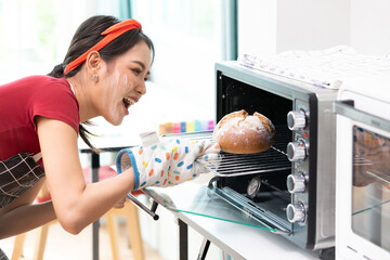 portrait young woman housewife baking bread from the oven