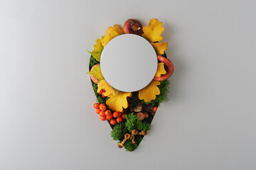 Creative autumn layout in the form of a geo-tag on a gray background with copy space.
